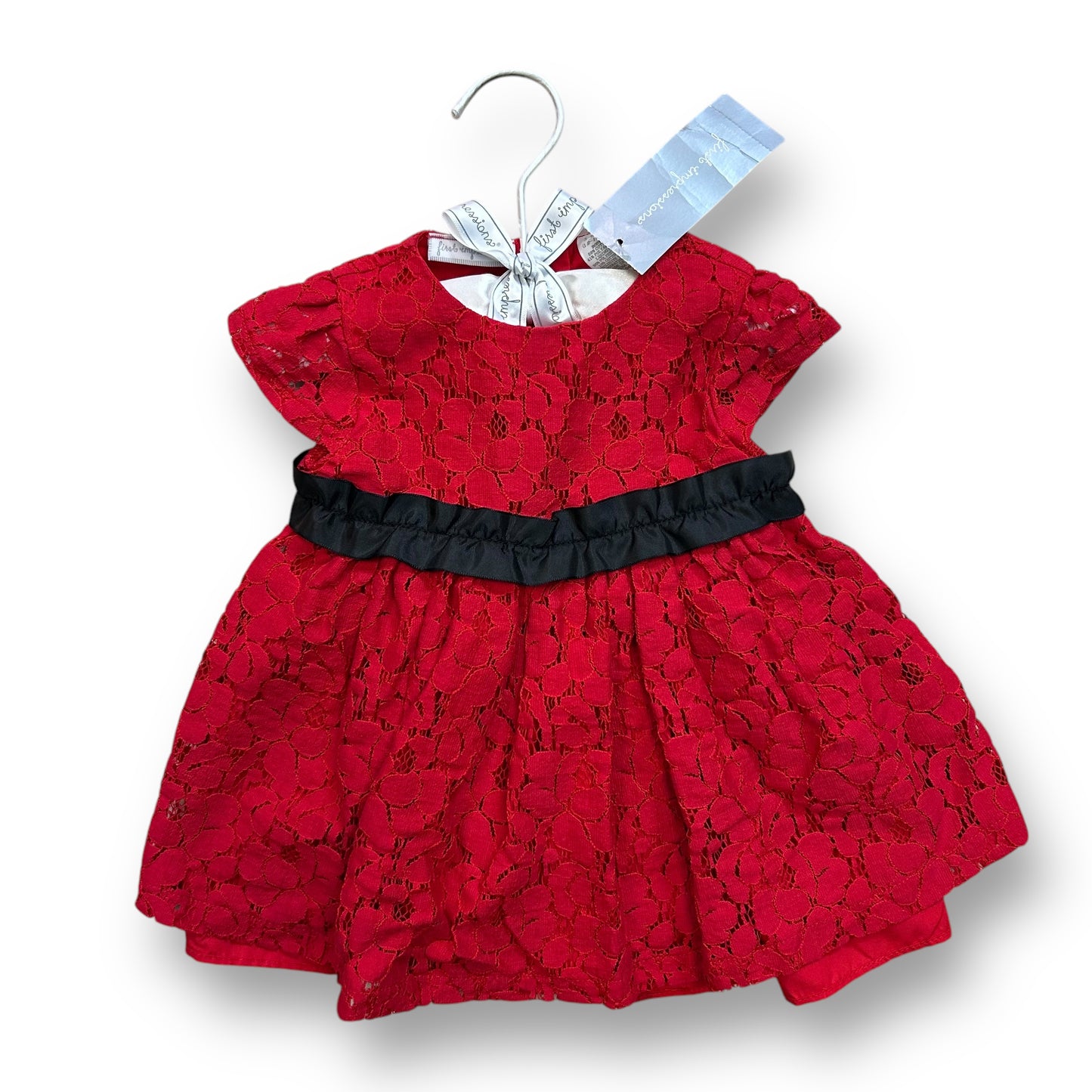 A red lace holiday dress for girls, with a solid pattern and a black belt, displayed on a hanger with a brand tag.