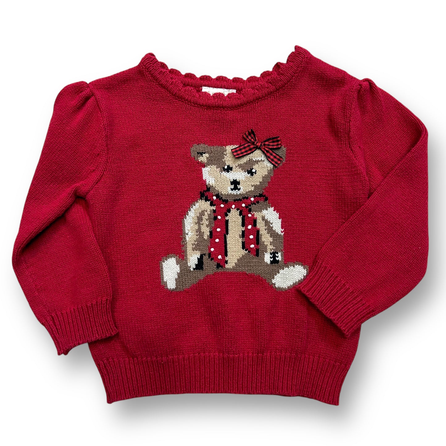 A red knit teddy bear sweater with a 3D bow on a child mannequin.
