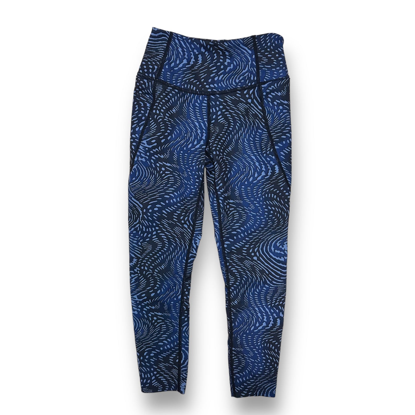A pair of girls' athletic performance leggings in blue with a geometric pattern.