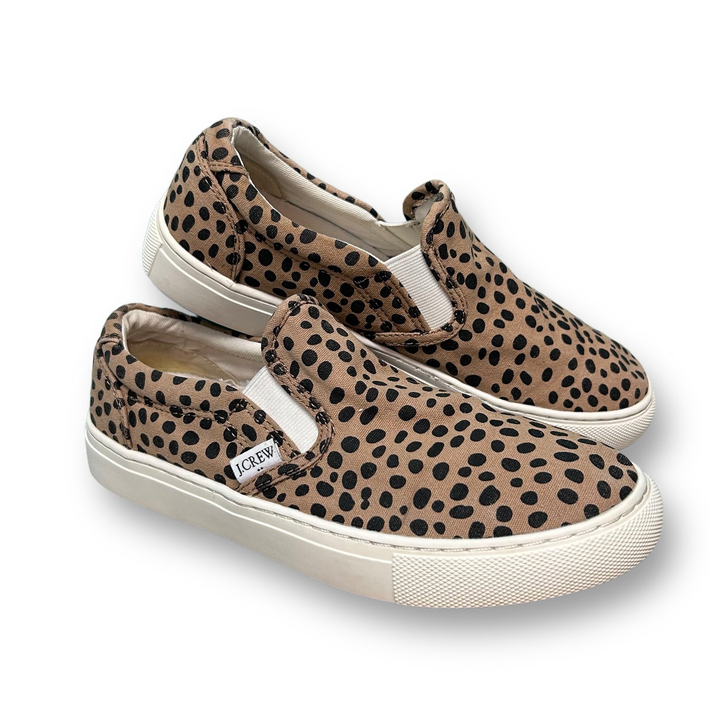A pair of J. Crew brown animal print canvas slide-on shoes for women.