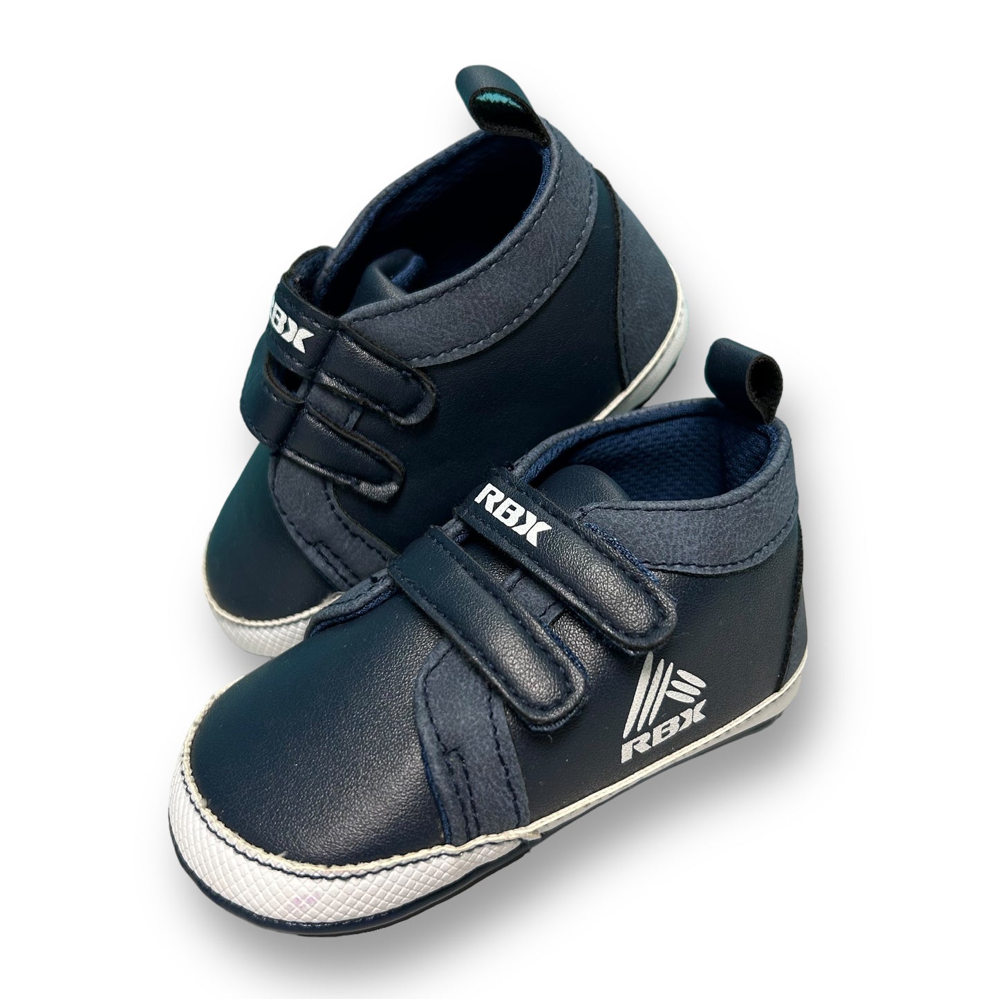 A navy-colored, leather style toddler sneaker with no-tie design and RBX branding on the side.