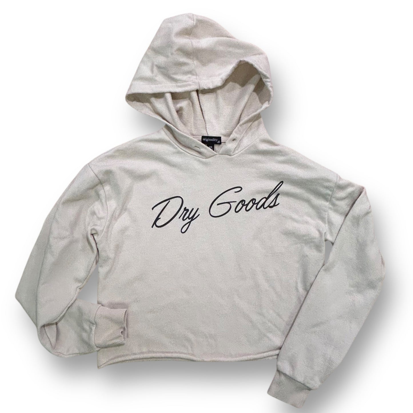 A beige cropped hoodie with the text 'Dry Goods' written across the front.