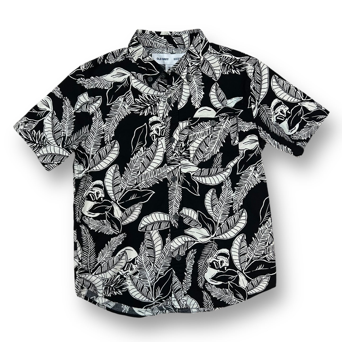 A black and white tropical print button down shirt for boys displayed on a hanger.