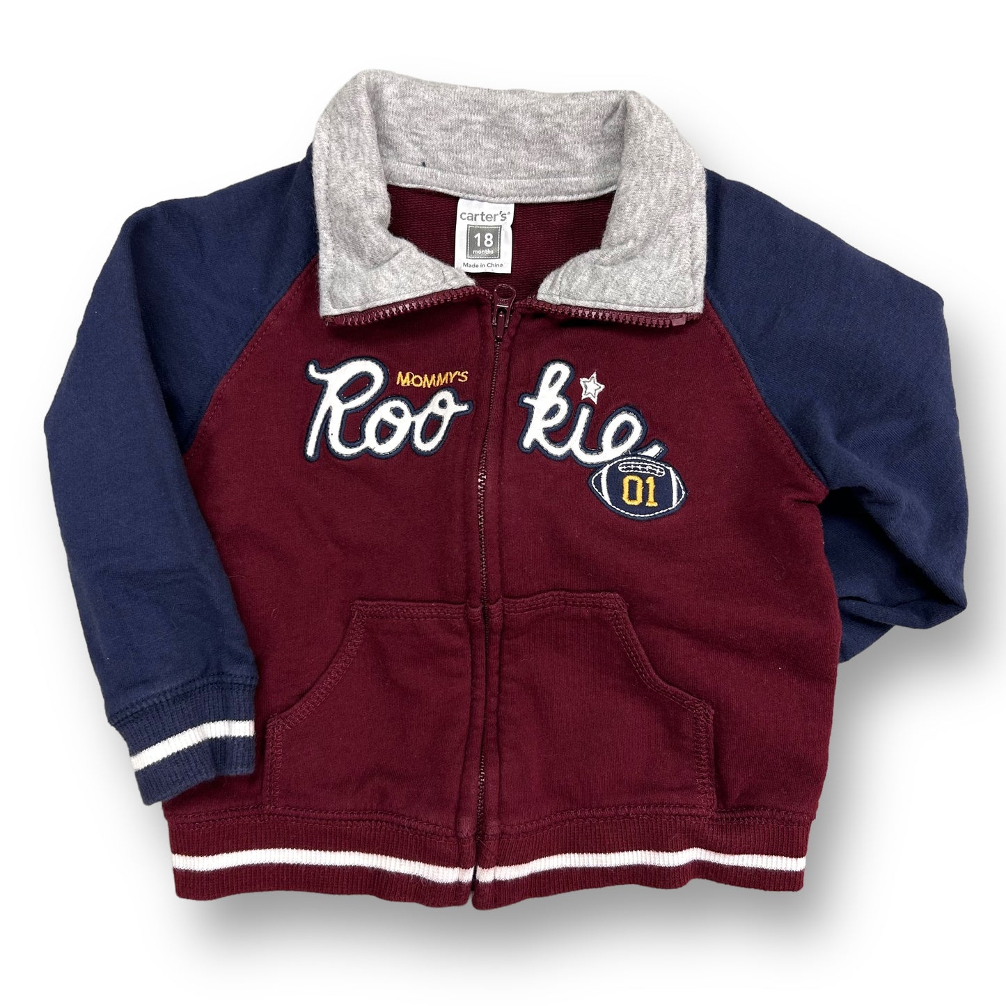 A maroon and navy zippered sweatshirt for boys with red and white accents and a logo on the front.
