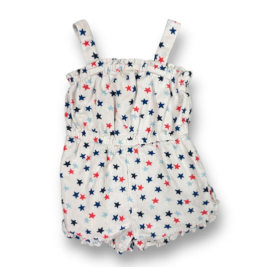 A girls' romper with red, white, and blue star print, featuring a short-sleeved top and pants.