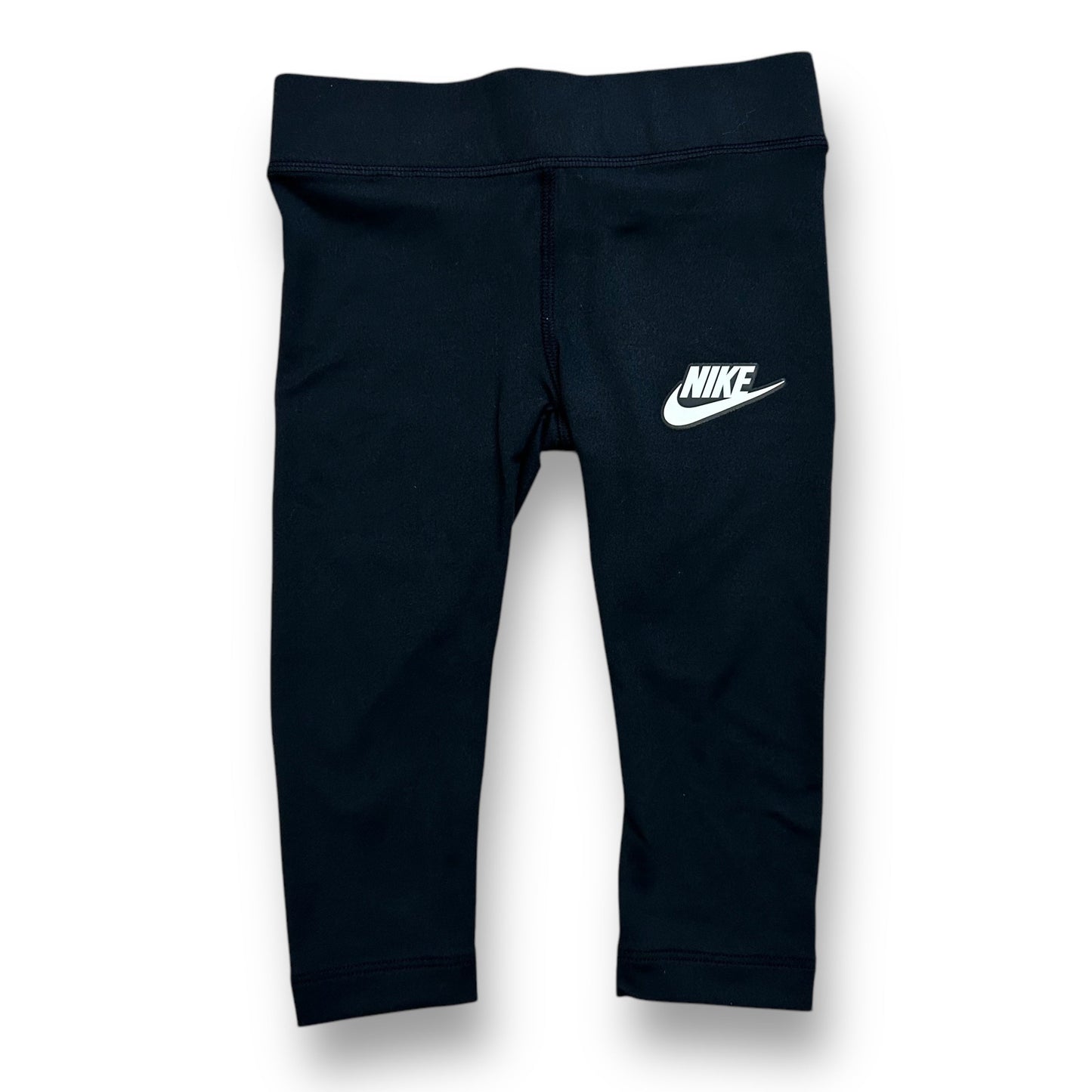 A pair of girls' Nike size 2T black athletic stretch capri leggings with a visible Nike logo on the upper left thigh.