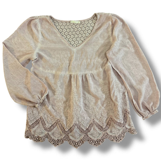 Women's pink blush boho style blouse with long sleeves and lace detailing on the cuffs and hem.