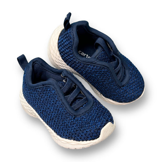 A pair of dark blue no-tie comfy sneakers for toddlers by Carter's.