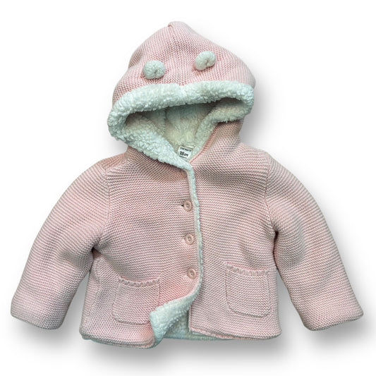 A pink knit sweater coat with a Sherpa lining for a baby girl, featuring a hood and a frontal button.