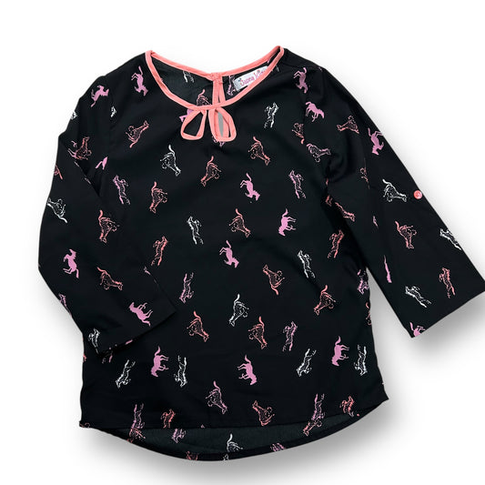 A black blouse with horse print, featuring 3/4 sleeves and a bow neckline.