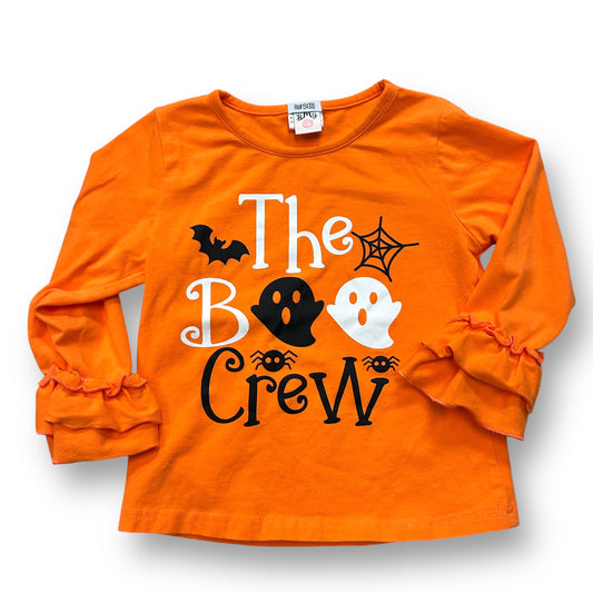 An orange long-sleeve top with 'The Boo Crew' text and Halloween-themed decorations like bats, pumpkins, and ghosts.