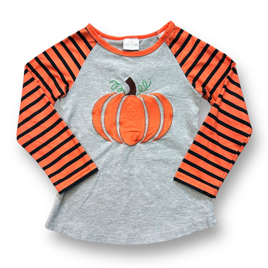 A long sleeve fall top for girls with stitched pumpkin and striped pattern on gray background.