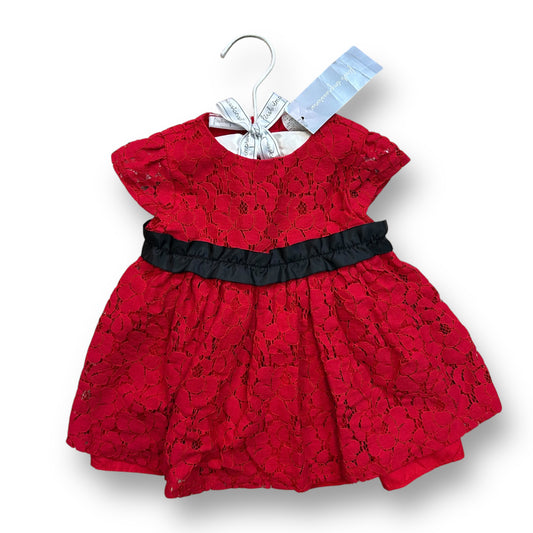 A red lace holiday dress for girls, with a solid pattern and a black belt, displayed on a hanger with a brand tag.