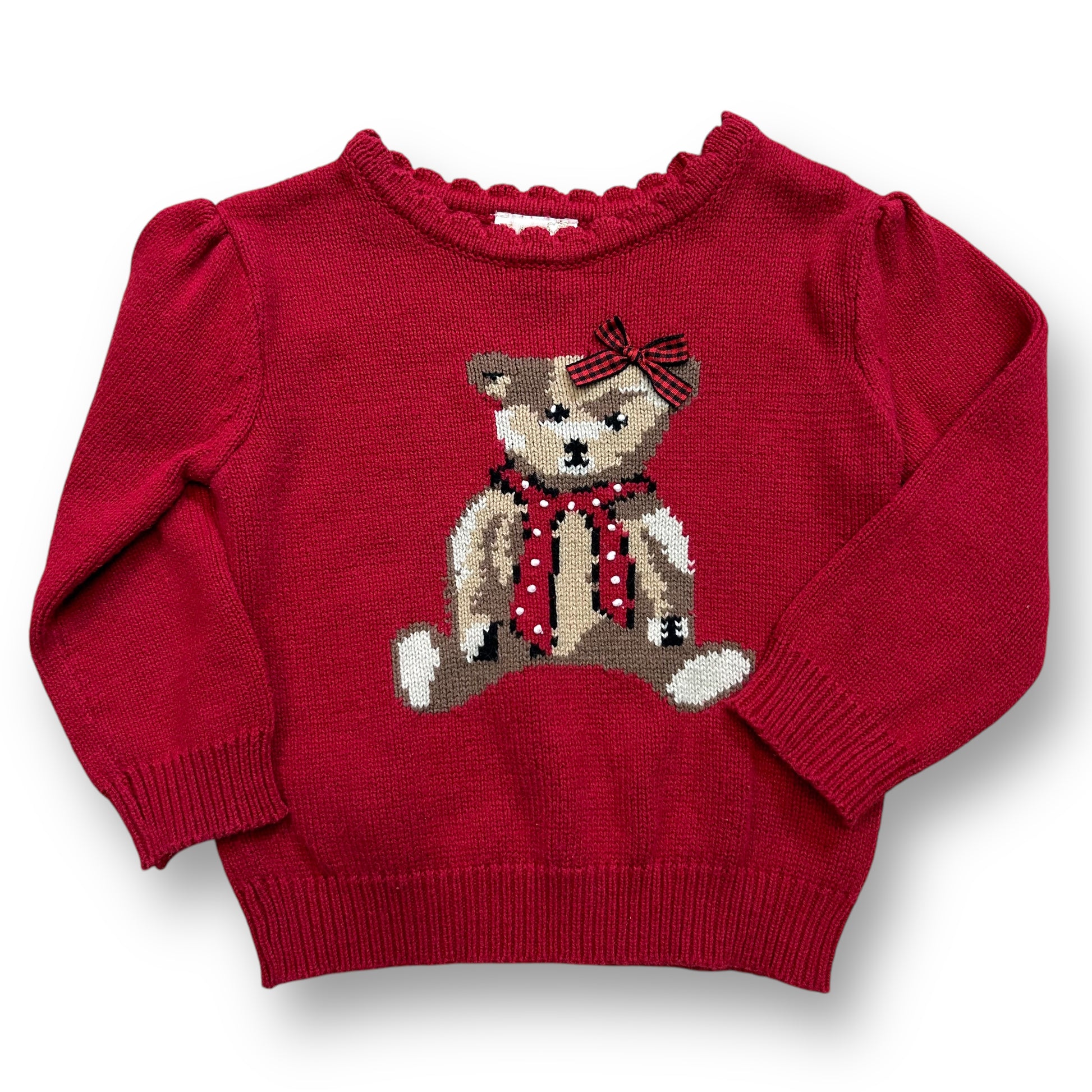 A red knit teddy bear sweater with a 3D bow on a child mannequin.