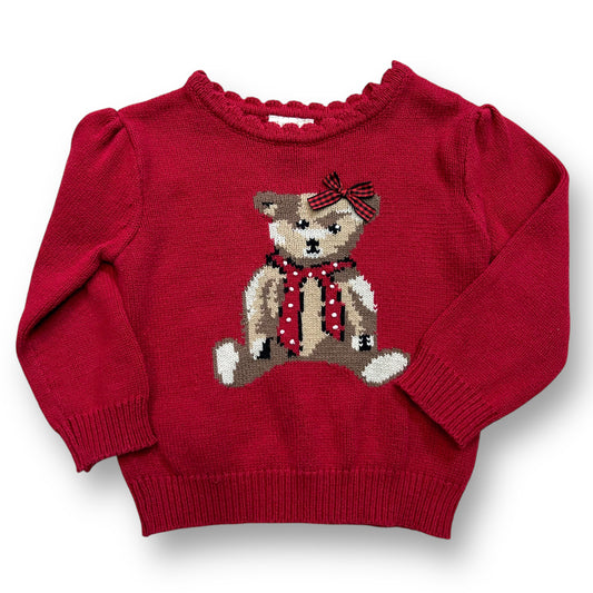 A red knit teddy bear sweater with a 3D bow on a child mannequin.