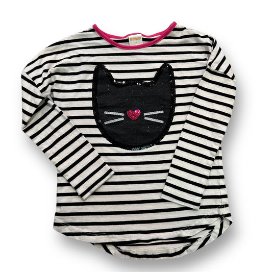 A long sleeve black and white striped sequin kitty shirt for girls, with a pink bow detail and heart shape on the sequin kitty face.