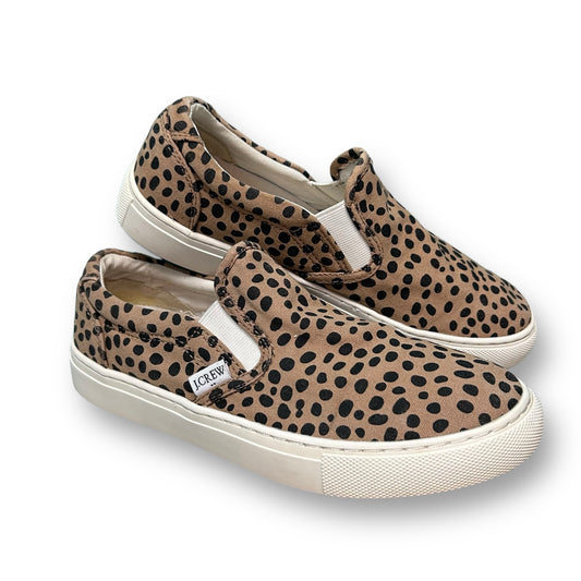 A pair of J. Crew brown animal print canvas slide-on shoes for women.