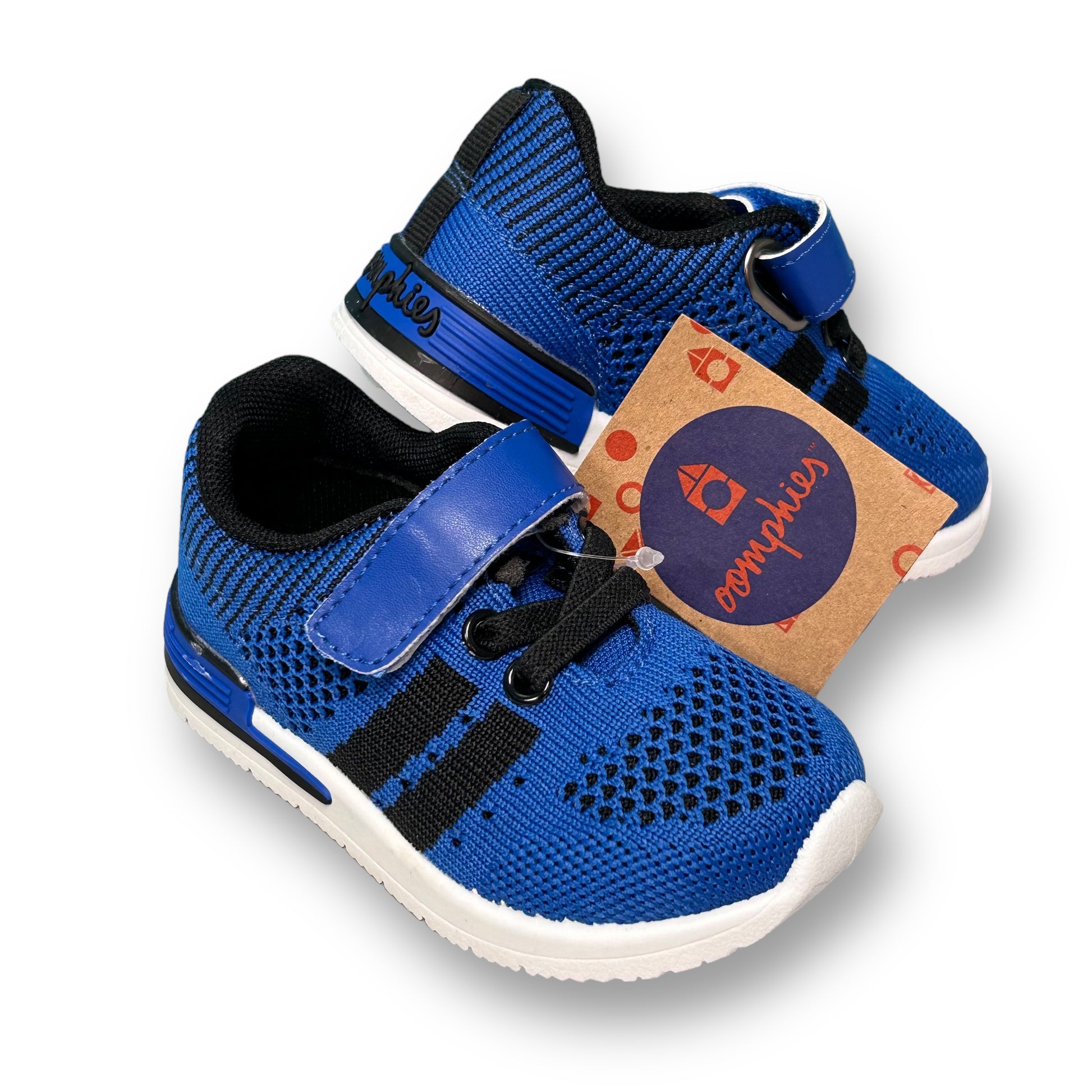 A pair of royal blue toddler boy size 5 no-tie sneakers with a label attached to the upper right corner.