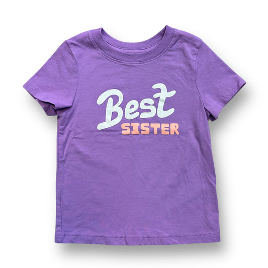 Lavender colored girls' t-shirt with 'Best Sister' printed in white and pink letters on the front.