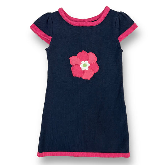 A navy and pink knit flower accent sweater dress for girls, with a round neckline and short sleeves.
