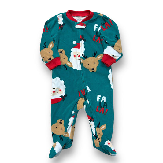A green fleece footie pajama set for a 9-month-old boy, featuring a Santa Claus and reindeer design with red trim.