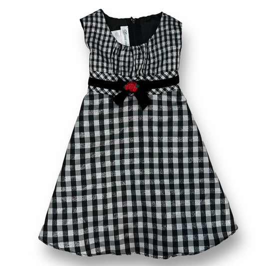 Girls' Bonnie Jean checkered holiday dress in black and white with a shimmering pattern and a red belt buckle.