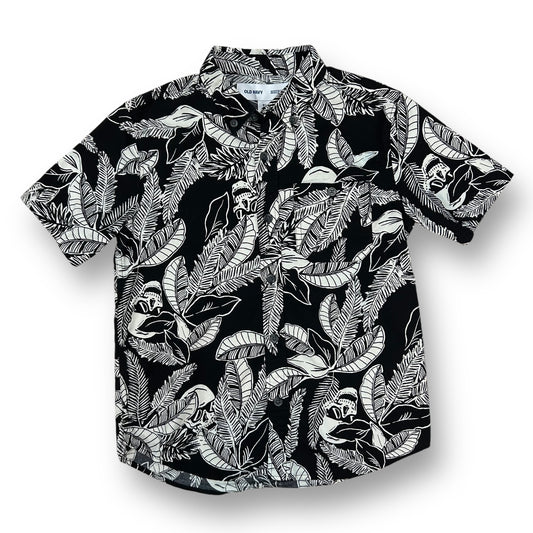 A black and white tropical print button down shirt for boys displayed on a hanger.