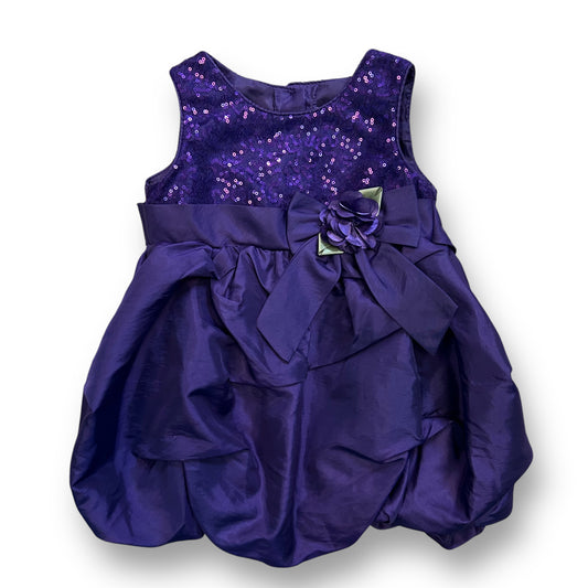A dark purple girls' dress with sequins and a bow detail on the waist.