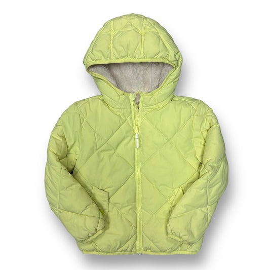 Bright green girls' winter coat with a sherpa hood, featuring a front zipper and a visible brand logo on the lower left side.