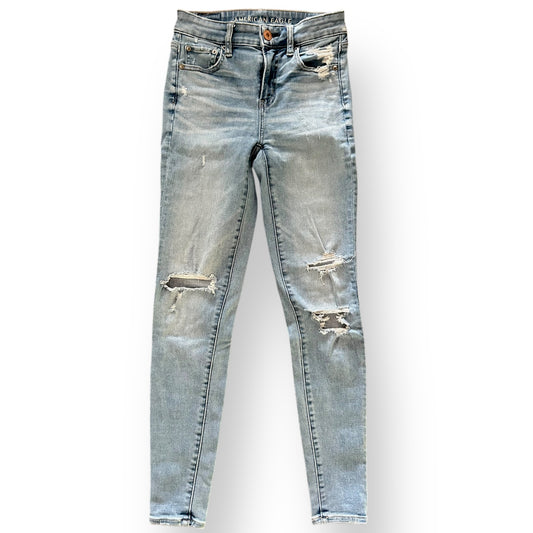 Distressed American Eagle jeans on a white background