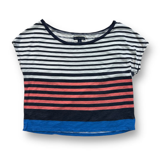 A loose fit, short sleeve top featuring horizontal stripes in varying shades of black, white, red, and blue.