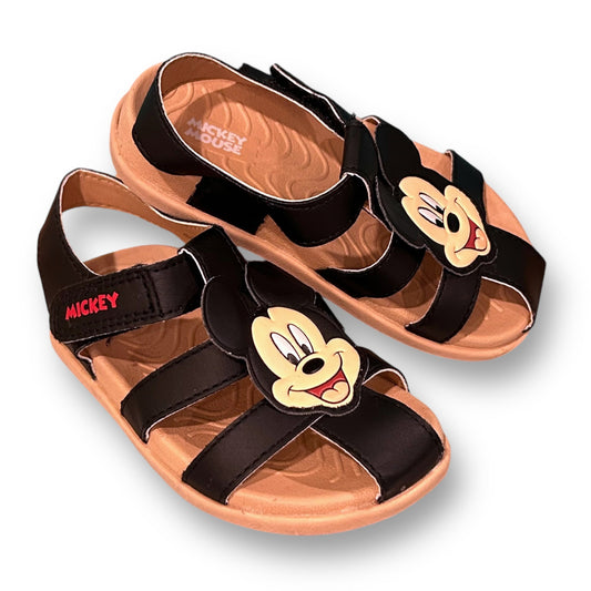 A pair of toddler boy size 7 sandals with a Mickey Mouse silhouette on the strap.