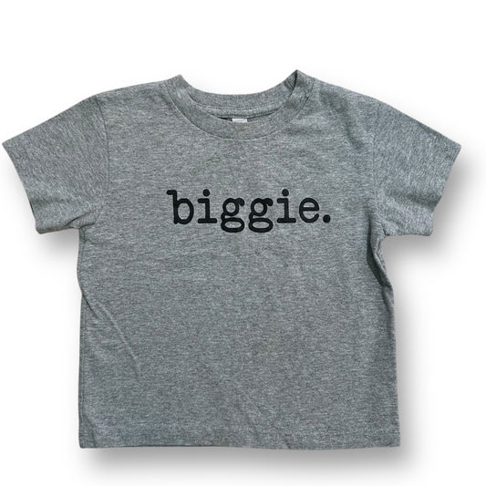 A short-sleeved light gray t-shirt with the word 'BIGGIE.' printed in black on the front.