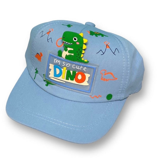 A blue toddler hat with a dinosaur design and the text 'I'm so cute DINO'.