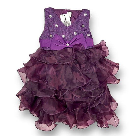 Girls size 3/4 purple silky ruffle fancy dress with a bow detail in the center.