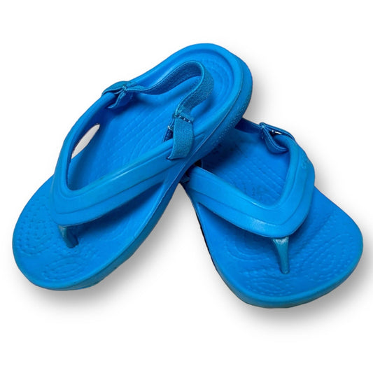 A pair of blue Crocs thong sandals for toddlers.
