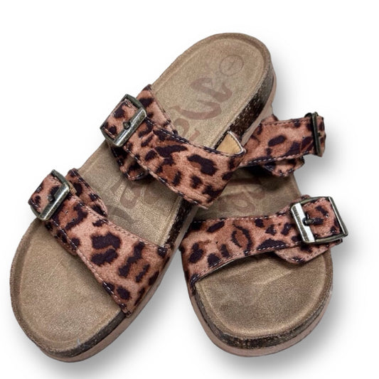 A pair of brown suede slide-on sandals with an animal print design, featuring multiple straps and a simple, sleek silhouette.