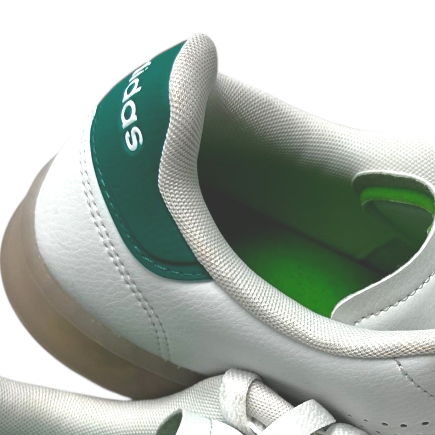White and green Adidas sneakers on a white background
