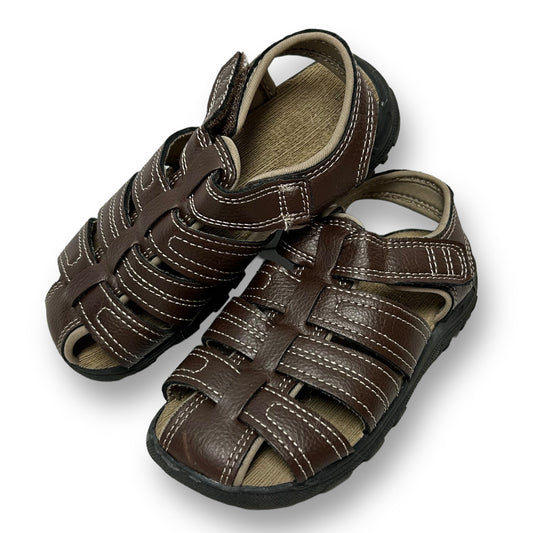 A pair of brown faux leather easy-on sandals for boys.