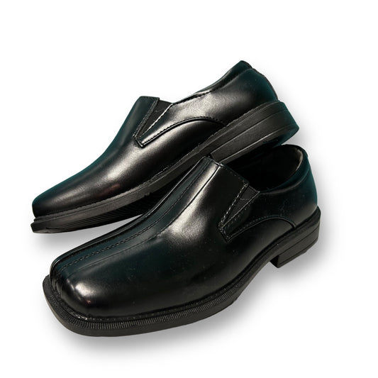 A pair of black Deer Stags Wings youth boy size 1 slip-on loafers displayed against a white background.