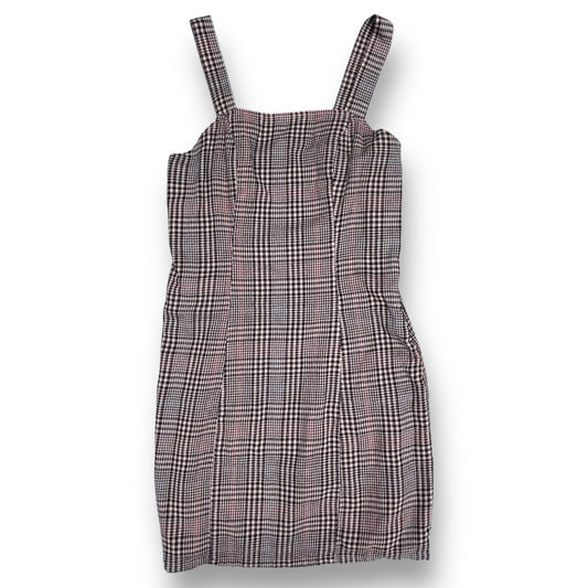 A checkered plaid jumper for girls, with a V-neckline and sleeveless design, in a gray, pink, and blue color scheme.