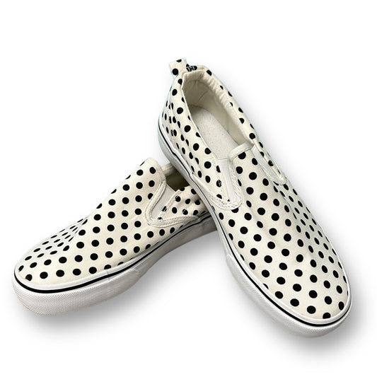 A pair of black and white dotted canvas youth girl slip-on shoes